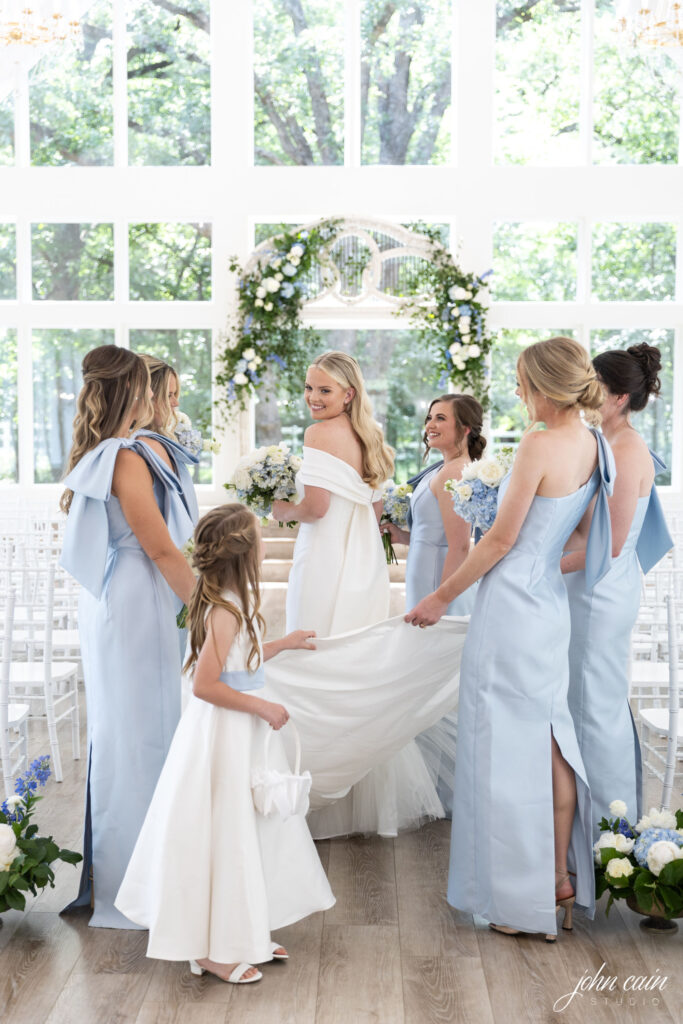 Bridal party in blue with ceremony florals by Sage Fine Flowers